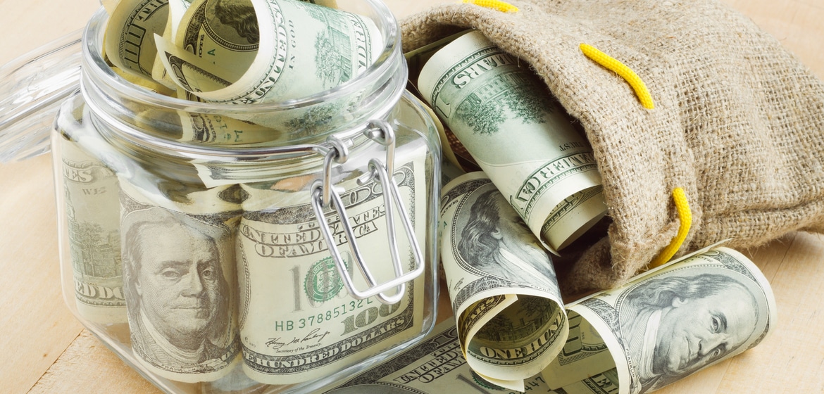 dollar banknote in glass jar and bag of money dollar banknote in glass jar and bag of money